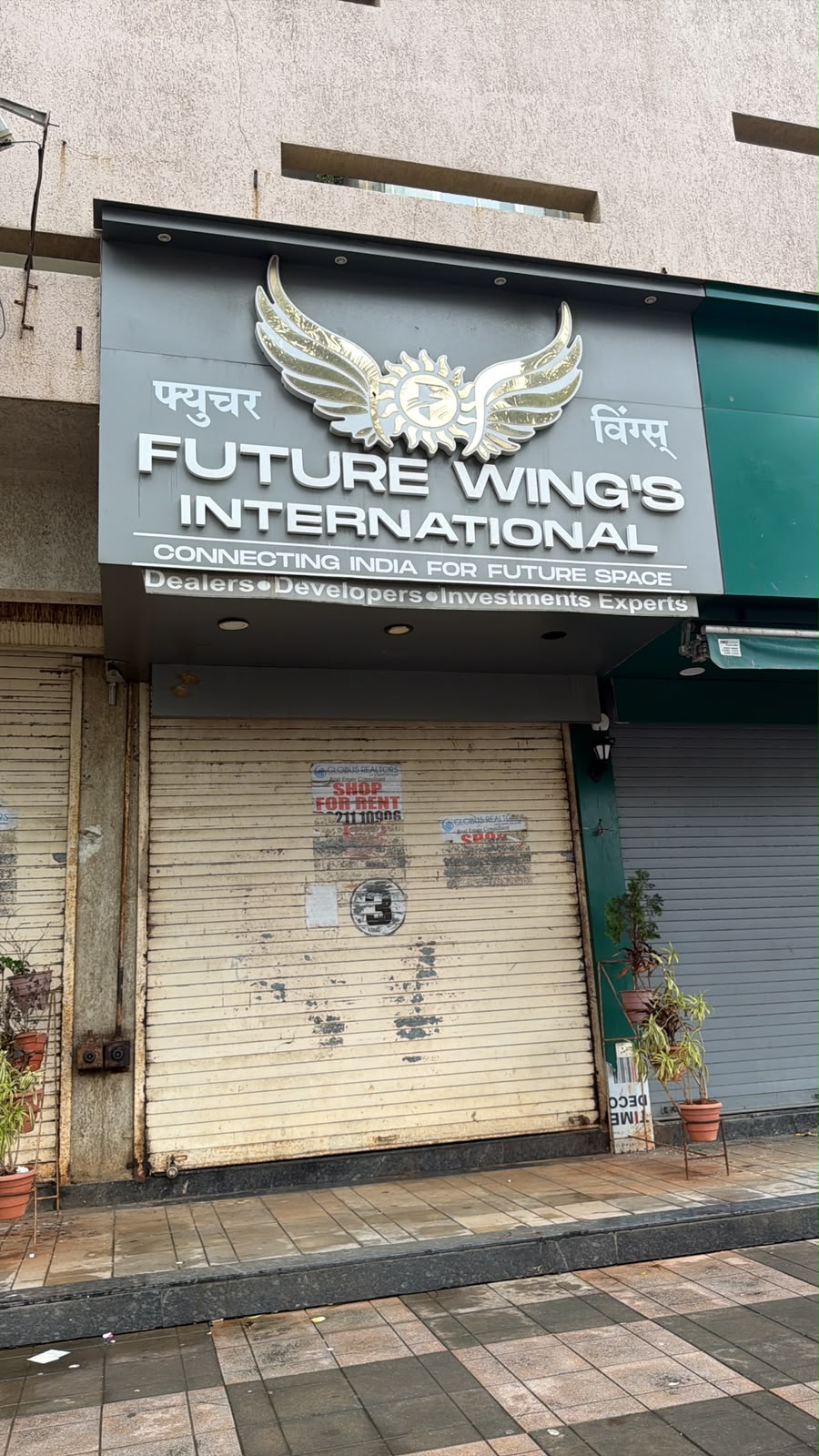 Future Wings International office with shutter down and shop-for-rent sign