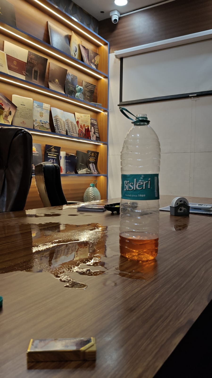 Office desk with liquid spilled across the surface
